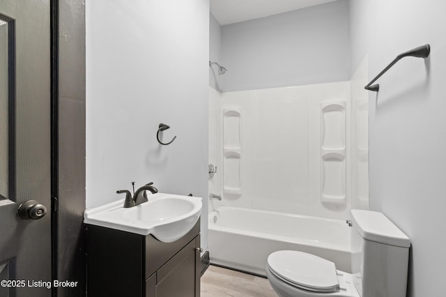 bathroom with shower / washtub combination, vanity, toilet, and wood finished floors