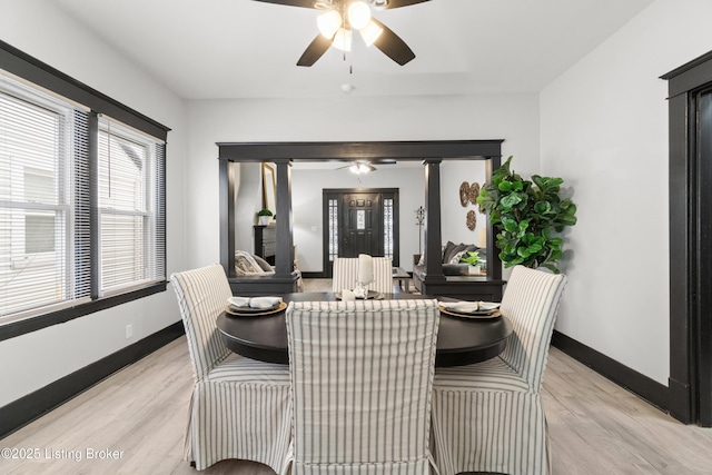 dining space featuring light wood-type flooring, ceiling fan, and baseboards