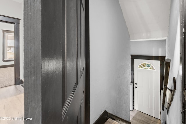 interior space with vaulted ceiling and wood finished floors