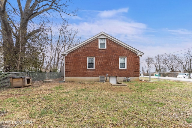 view of property exterior with a yard, a fenced backyard, and brick siding