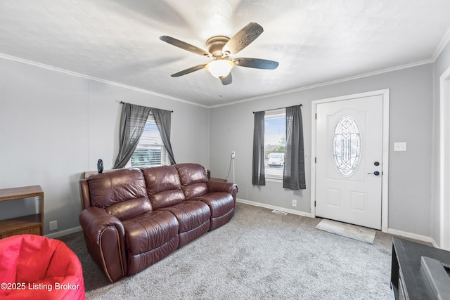 carpeted living area featuring a healthy amount of sunlight, crown molding, and baseboards