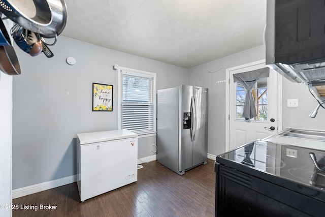 kitchen with refrigerator, black range with electric stovetop, dark wood-type flooring, a sink, and stainless steel refrigerator with ice dispenser