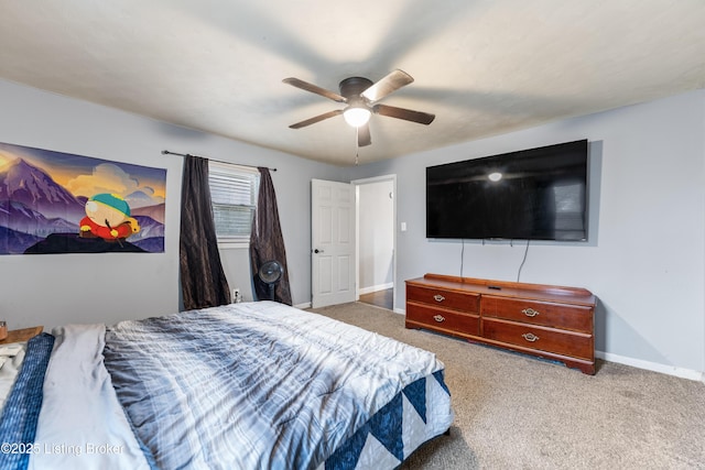 carpeted bedroom with a ceiling fan and baseboards