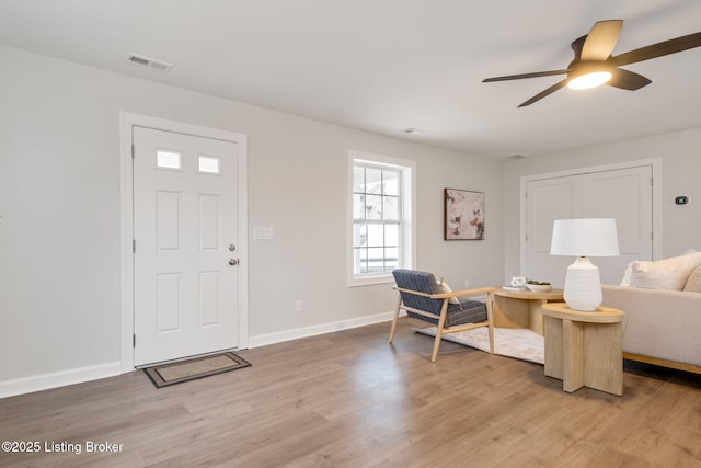 entrance foyer featuring light wood-style floors, visible vents, baseboards, and a ceiling fan