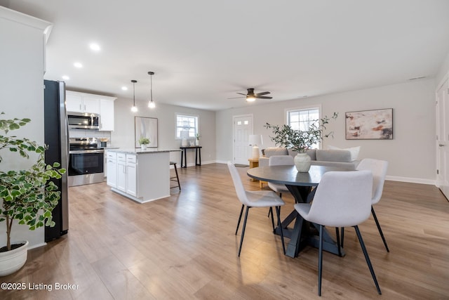 dining area featuring light wood-type flooring, plenty of natural light, baseboards, and recessed lighting