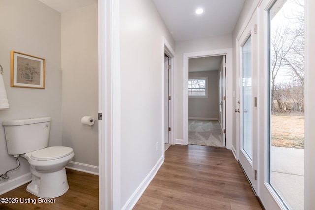 bathroom featuring wood finished floors, toilet, and baseboards