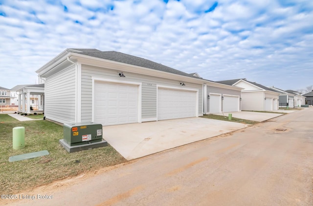 garage with a residential view and driveway