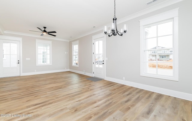 unfurnished dining area with crown molding, light wood-style flooring, baseboards, and ceiling fan with notable chandelier