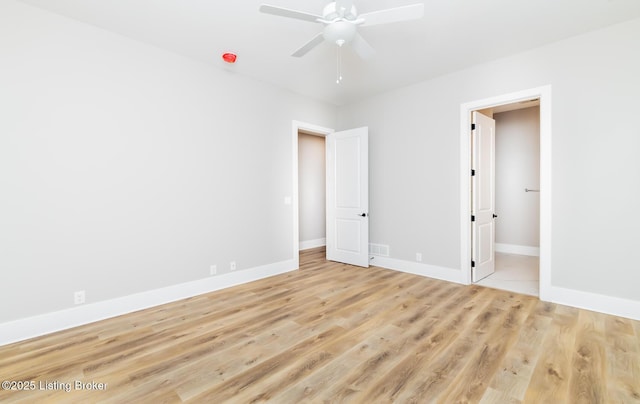 unfurnished bedroom featuring light wood-type flooring, baseboards, visible vents, and a ceiling fan