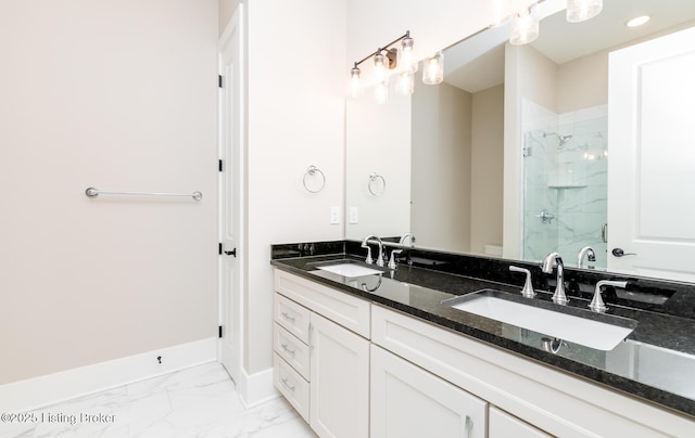 full bath with toilet, marble finish floor, a sink, and a stall shower