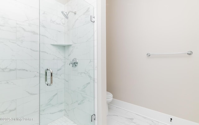 full bathroom featuring a stall shower, marble finish floor, toilet, and baseboards