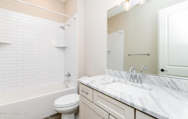 full bath with shower / tub combination, vanity, and toilet