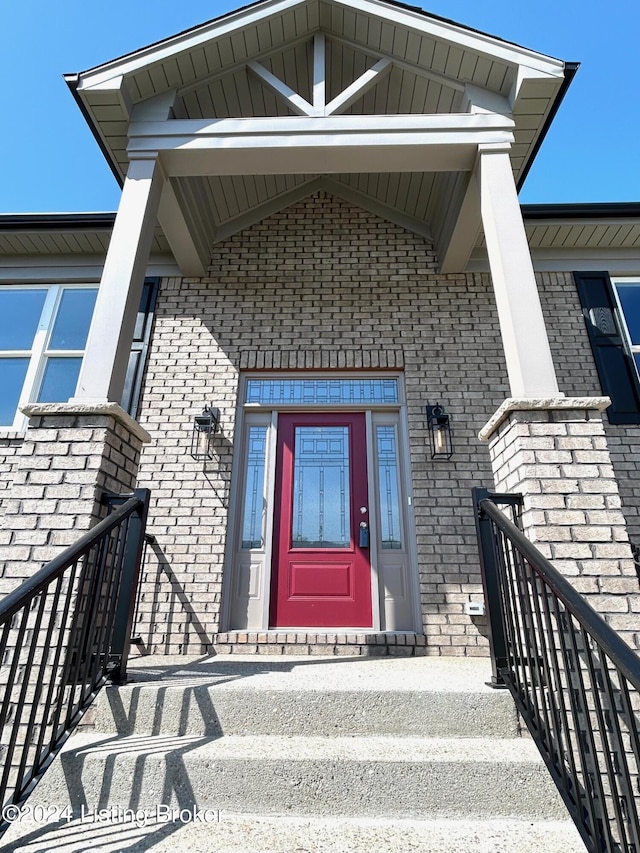 property entrance featuring brick siding