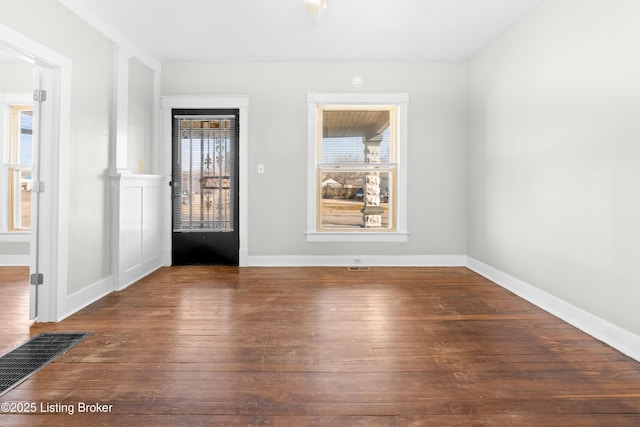 unfurnished room with hardwood / wood-style flooring and baseboards