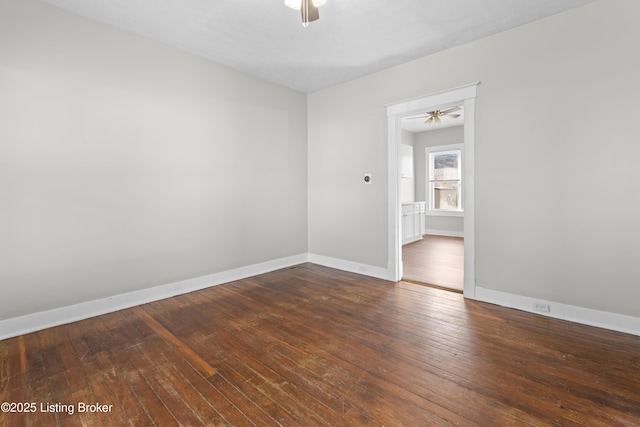 spare room with baseboards, a ceiling fan, and hardwood / wood-style flooring