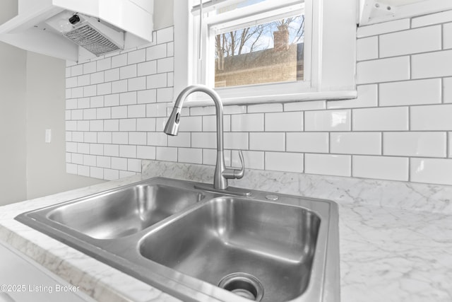 room details featuring backsplash and a sink