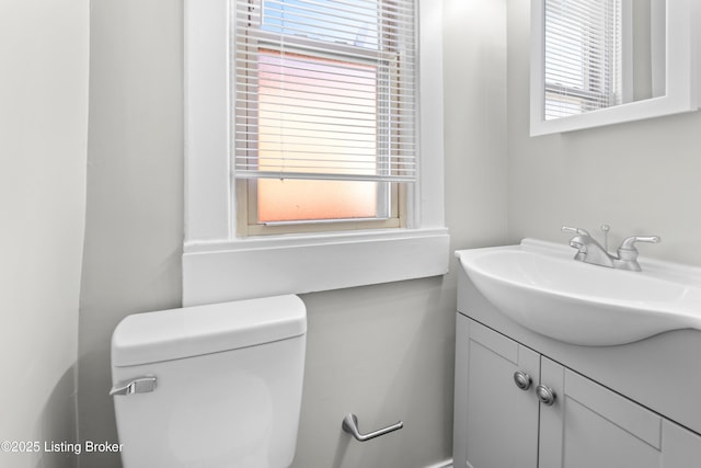 bathroom featuring vanity, toilet, and plenty of natural light