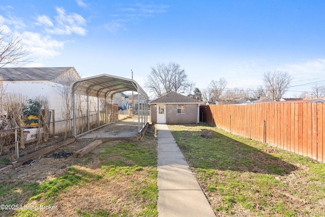 view of yard featuring a detached carport and fence