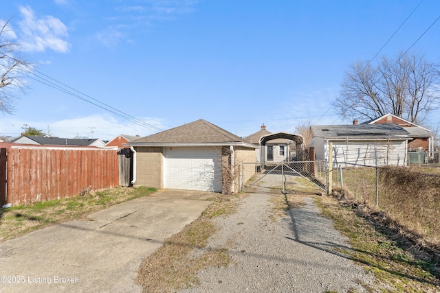 view of front of home featuring a gate, fence, a garage, and driveway