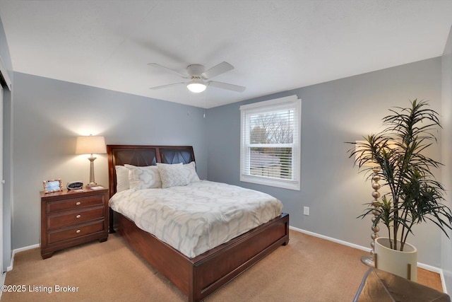 bedroom with baseboards, light colored carpet, and a ceiling fan