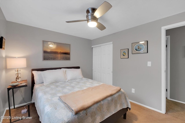 bedroom featuring a closet, baseboards, carpet, and a ceiling fan