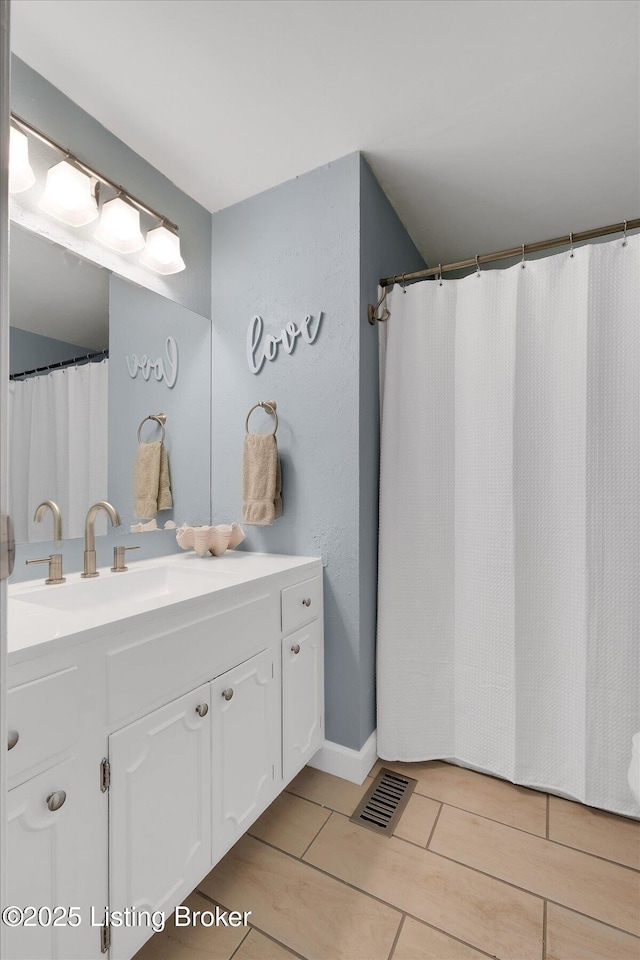 bathroom featuring vanity, tile patterned floors, and visible vents