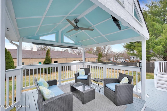 wooden deck featuring a ceiling fan, fence, a gazebo, a residential view, and an outdoor hangout area