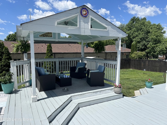 wooden terrace with an outdoor hangout area, a yard, and fence