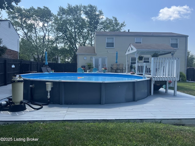 view of pool with a wooden deck, a fenced in pool, and a fenced backyard