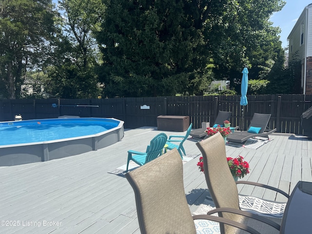 view of pool with a fenced in pool, a deck, and fence