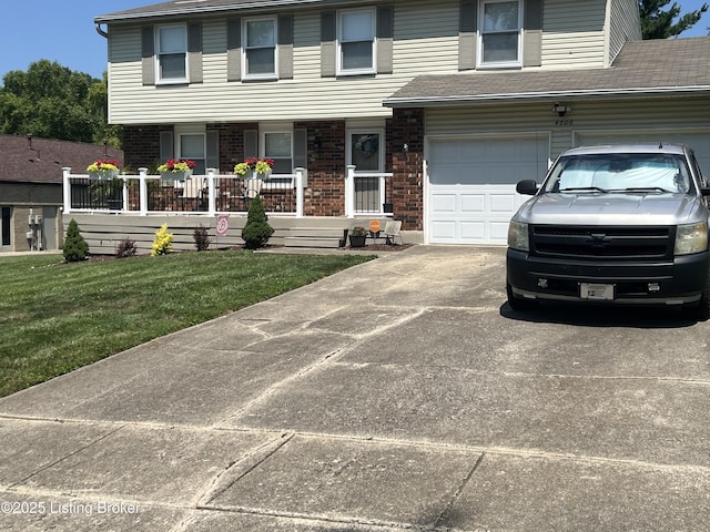 view of front of property featuring a front lawn, covered porch, concrete driveway, an attached garage, and brick siding