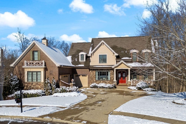 view of front of property with an attached garage, driveway, and brick siding