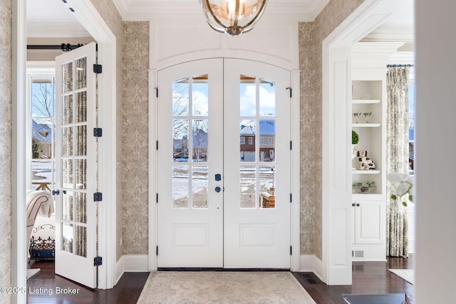 doorway featuring wallpapered walls, ornamental molding, and french doors