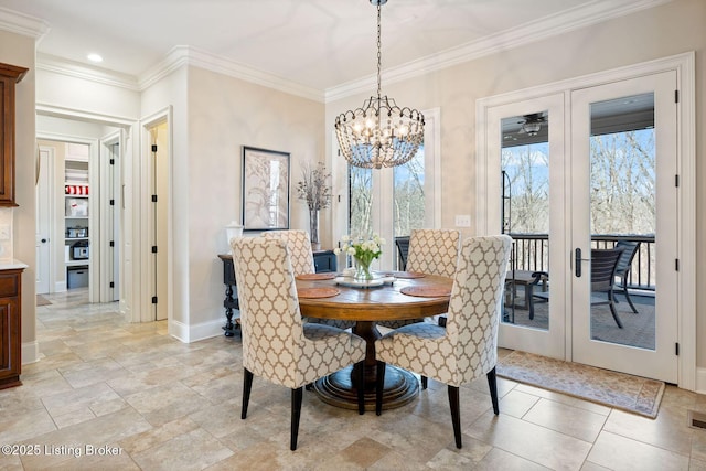 dining space with a notable chandelier, baseboards, and crown molding