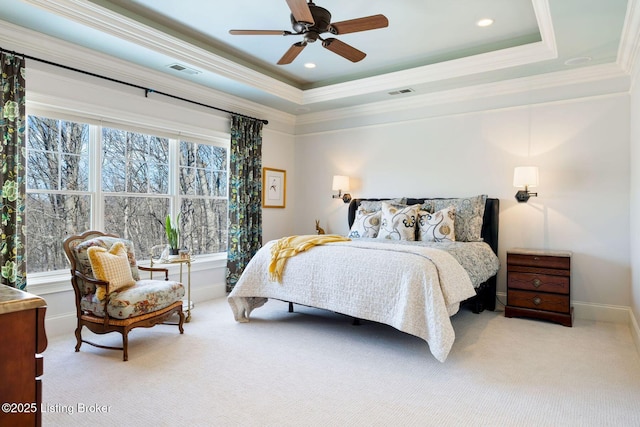 bedroom with crown molding, a raised ceiling, visible vents, and light colored carpet