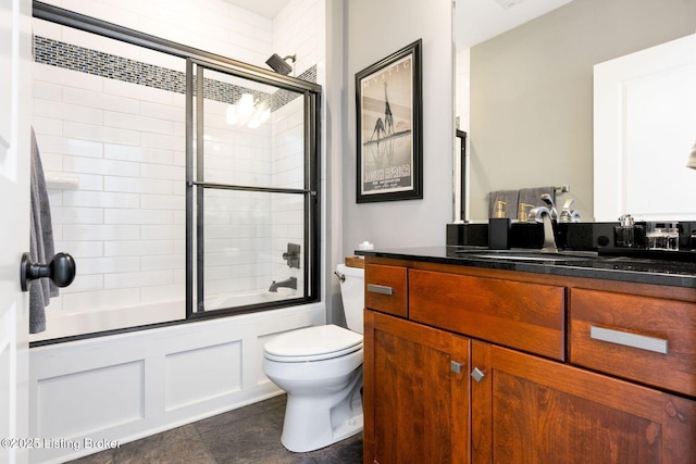 full bath with combined bath / shower with glass door, vanity, and toilet