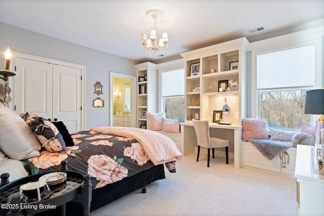 bedroom with light carpet, a closet, visible vents, connected bathroom, and a notable chandelier