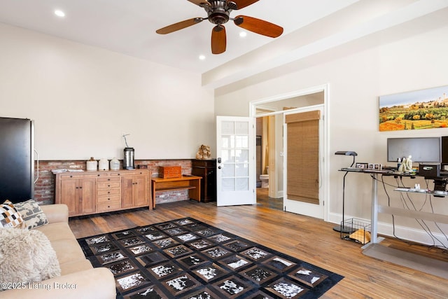 living area with ceiling fan, baseboards, wood finished floors, and recessed lighting