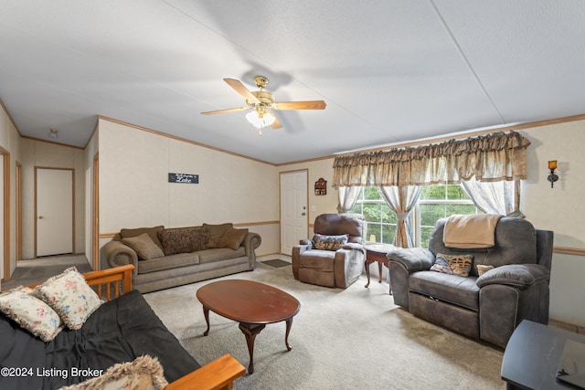 living room with ceiling fan, ornamental molding, and carpet flooring