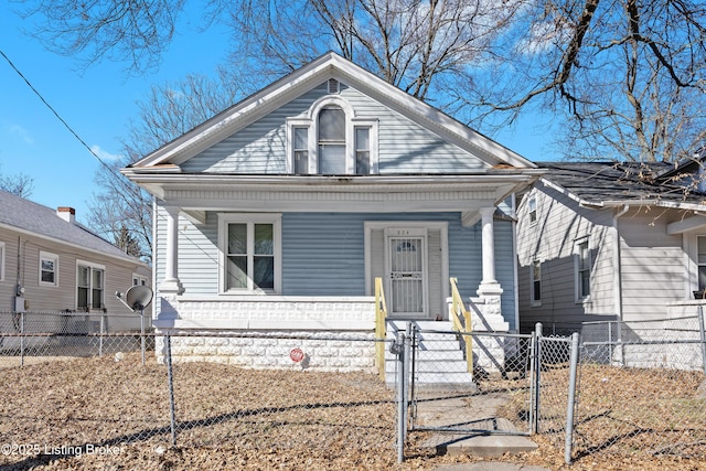 bungalow-style house with a porch, a gate, and a fenced front yard