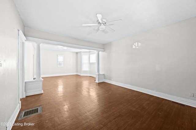 unfurnished living room with wood finished floors, visible vents, ornate columns, and ceiling fan