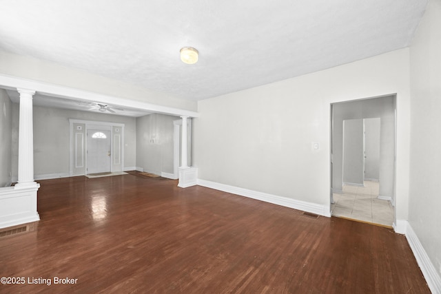 interior space with visible vents, ornate columns, and wood finished floors
