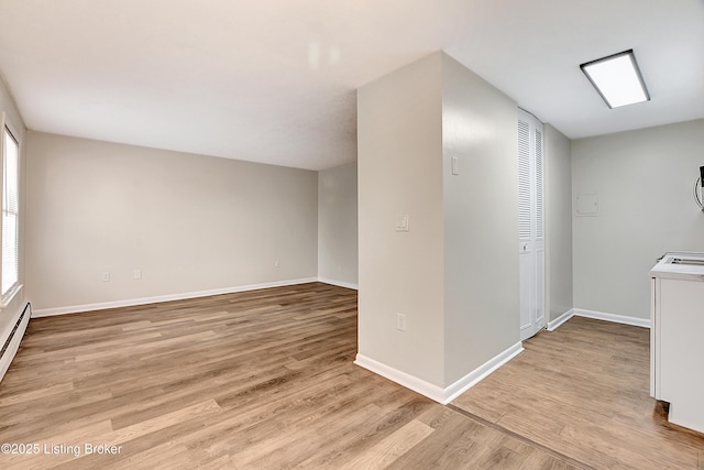 interior space featuring light wood-style floors and baseboards