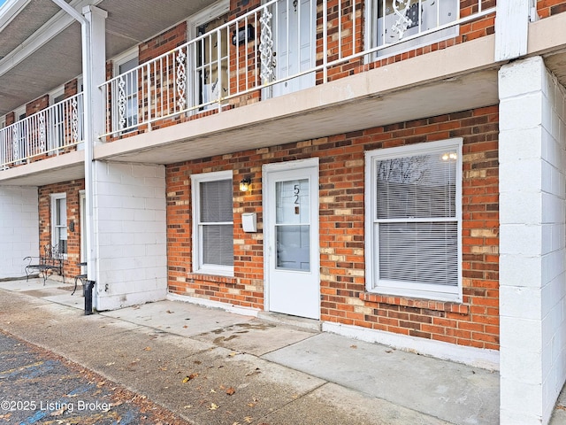 view of exterior entry with brick siding