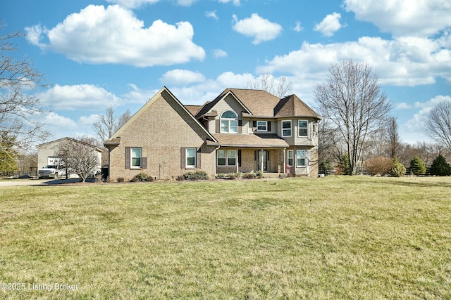 view of front of property featuring a front yard and brick siding