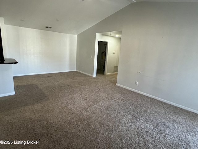 carpeted empty room featuring visible vents, vaulted ceiling, and baseboards