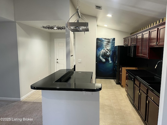 kitchen featuring visible vents, dark countertops, lofted ceiling, black appliances, and a sink