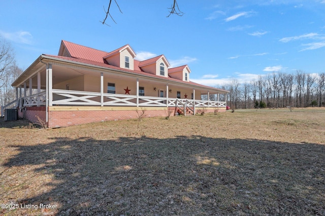 view of side of home featuring metal roof and central AC unit