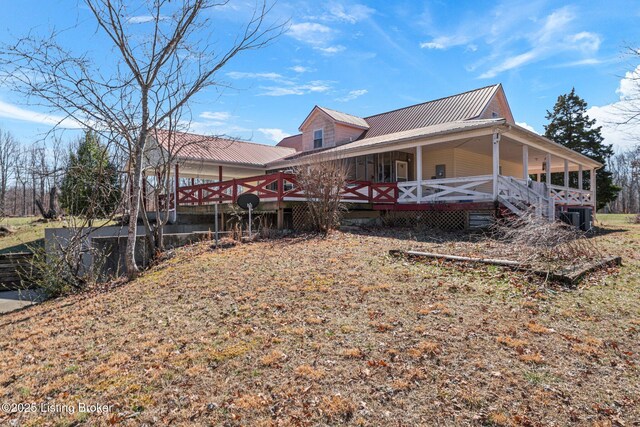 exterior space featuring covered porch and metal roof