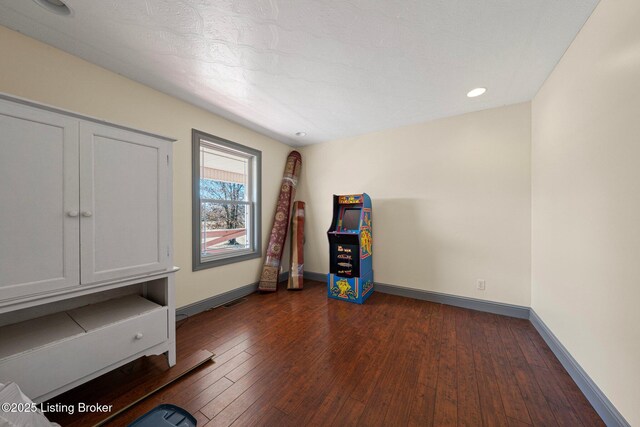 interior space featuring dark wood-style floors, visible vents, and baseboards